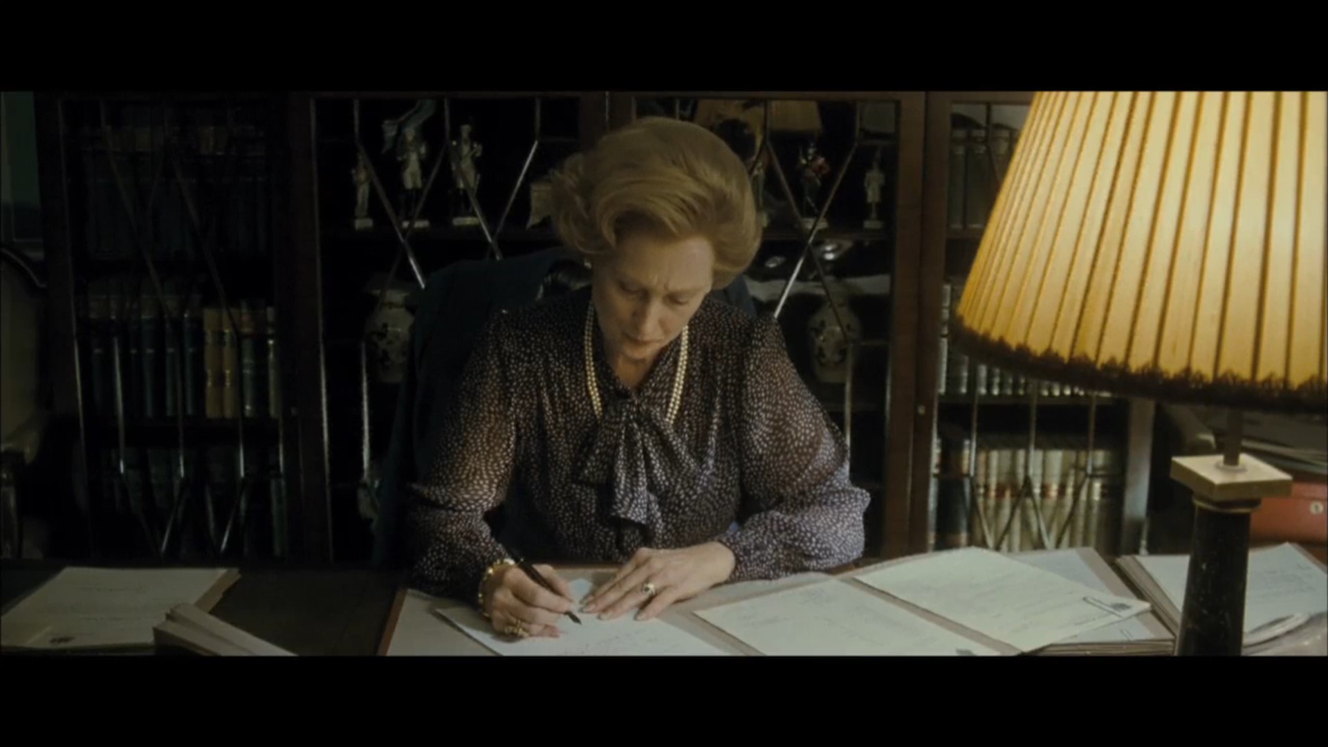 Margaret Thatcher writing a handwritten letter to a bereaved family with tears in her eyes (Source - The Iron Lady)